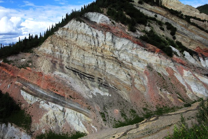 Red seams of fired clay mark where black coal smoldered.