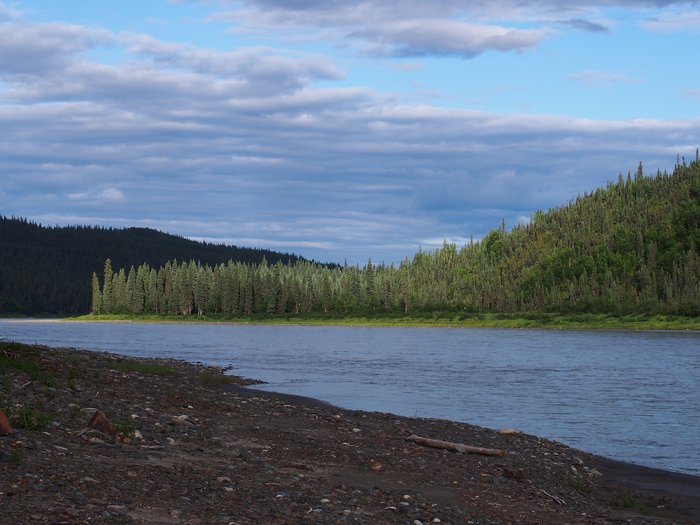 A low sun lights tree-covered bluffs which would be covered by the reservoir