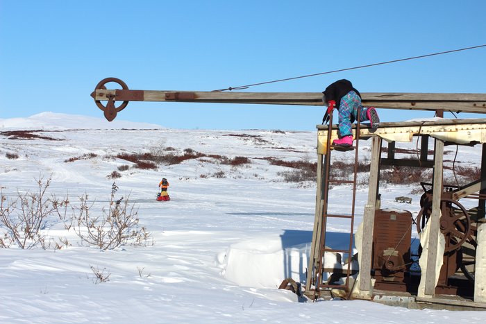 Katmai clambers up an old piece of mining equipment.