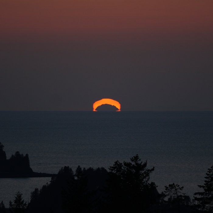 Or perhaps it's just the sun, silhouetted behind a distant, usually invisible mountain.