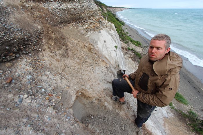 Andrew Mattox doing geology on the shore of Lake Iliamna.