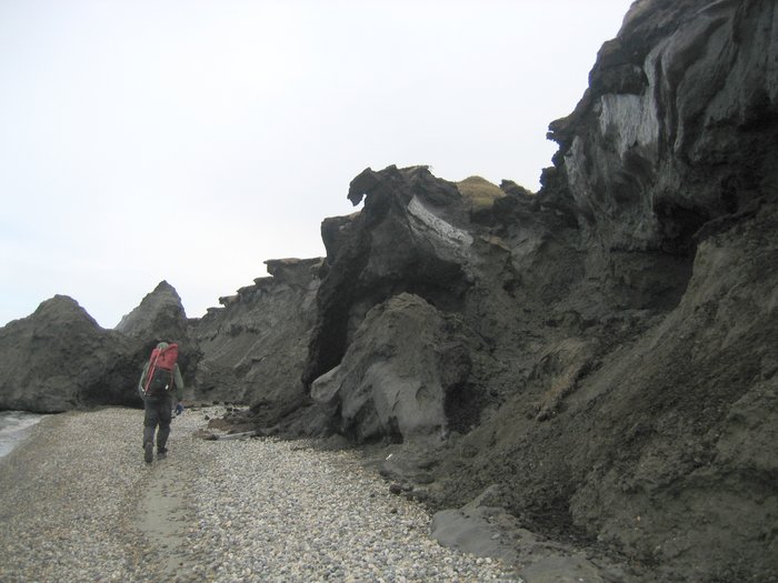 Near Kaktovik on the Arctic Ocean, permafrost bluffs melt along the beach.