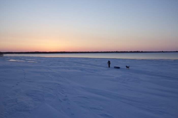 Skiing into Igiugig just before sunset. The Kvichak River is shown in the background.