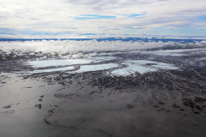 The white is overflow ice (aufeis), and is nearly perennial, and is marked on most maps of the area.
