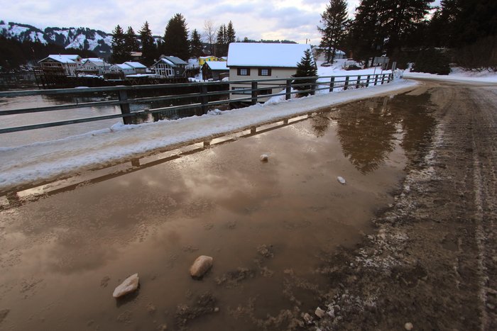 Meltwater on a bridge over air over ocean in Seldovia.