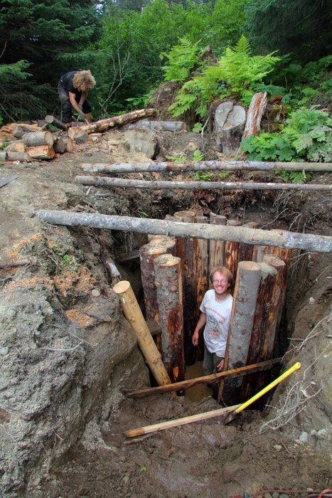 Hig stands in a partially finished wooden well.