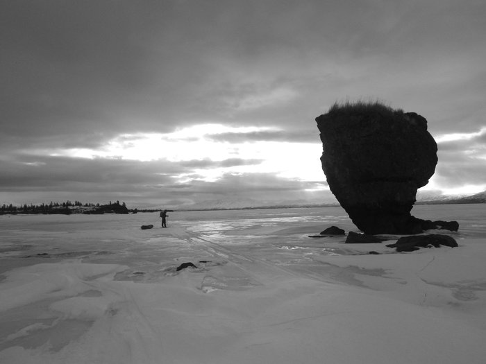 Caleb skis past some surreal rock formations on the eastern end of Lake Iliamna