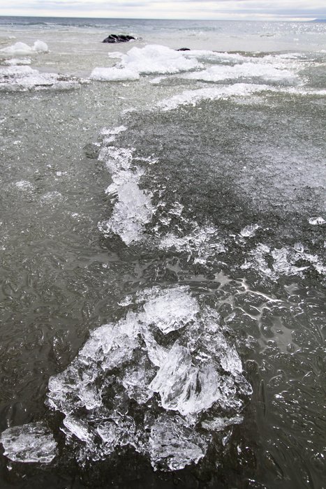 Lake Iliamna was nearly completely clear of ice, and the remaining ice floes along its edge were breaking apart in the waves.
