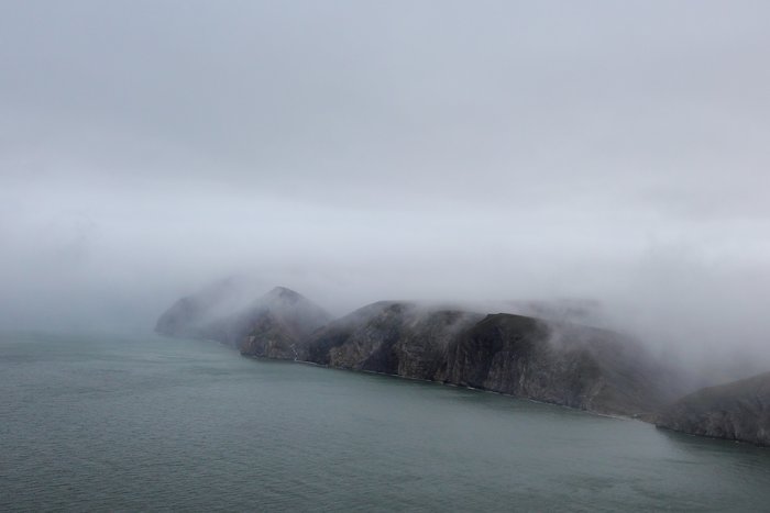 We were able to fly high here - a rarity in a week of low hanging clouds.  But the fog wasn't far away - draping over the land like a oozing blanket.