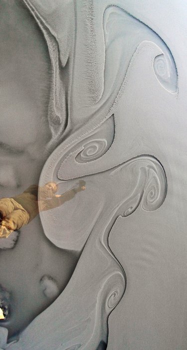 Clay washed down during a warm spell mixes with clear seawater.