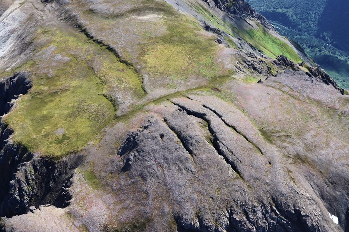 Deep fissures cross the summit of Alpine Ridge above Grewingk Lake.