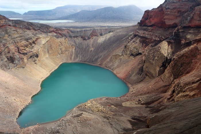 An epic view - volcanic crater, the vast expanse of Okmok Caldera, and the gap where Crater Creek flows out to the Bering Sea.