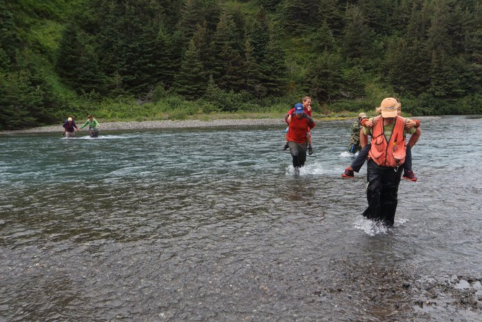 Kids get piggyback rides across the creek in upper Tutka valley