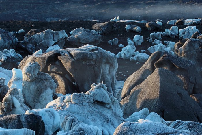 Mist and sunlight hit the stranded bergs of Oily Lake on a chilly dawn.  This ice-dammed lake can drain out underneath Malaspina Glacier, leaving icebergs stranded on glacial silt.
