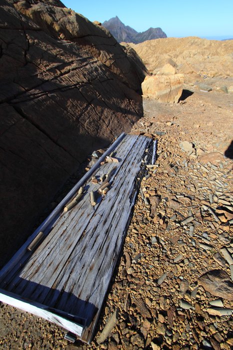 Harsh alpine weather has scattered rock cores once stored in this wooden box.
