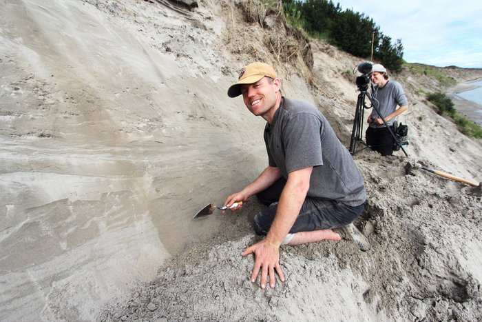 Hanna Craig films Andrew Mattox cleaning outcrop.