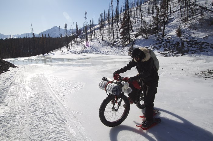 Overflow ice can be very slippery. Crampons are needed to cross these short sections of the Iditarod Trail.
