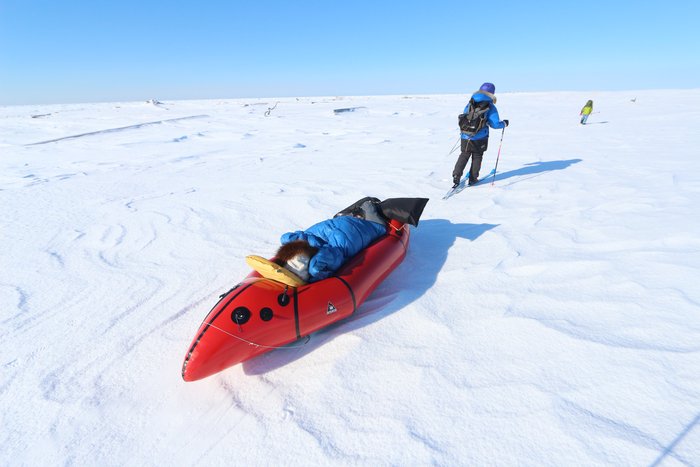 Erin pulling Lituya in the packraft-sled