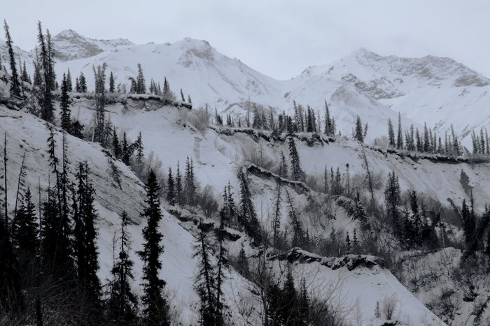 Snow highlights the sedimentary bluffs on the Matanuska River, in a monochrome January scene 