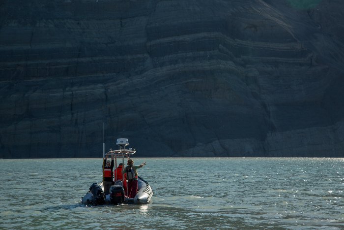 Jim Capra, Colin Bloom and Hig take an evening cruise in the park service skiff to place "control points". In this case the control points were plastic five gallon bucket lids with targets painted on them. These can be seen from the air and help with aerial surveying the fjord. 