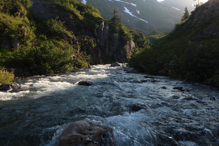 A shaft of light touches down in a gorge in upper Tutka