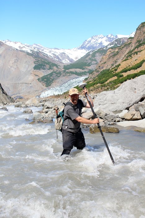 The Trimble antenna Andrew Mattox is carrying across this stream costs several thousand dollars - extra motivation to take careful steps.