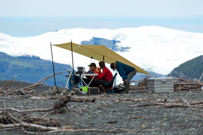 The marine survey crew looks at data being gathered by the remote control boat, in real time. 