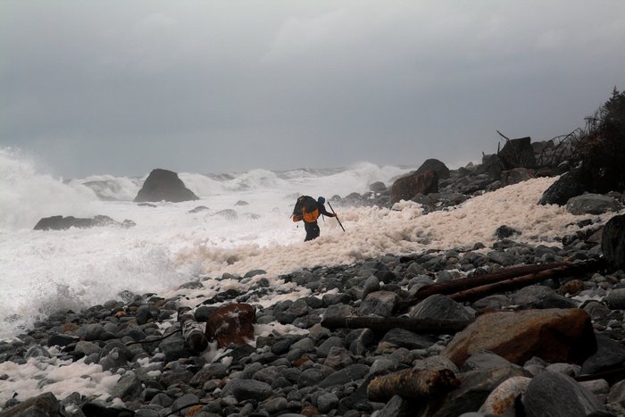 Storm waves build waste deep, jiggling waves of foam.