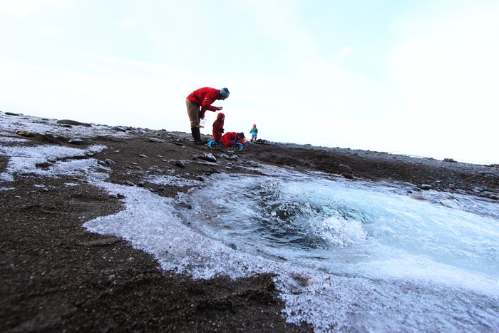Roiling water surges up and flows into the waiting tide.