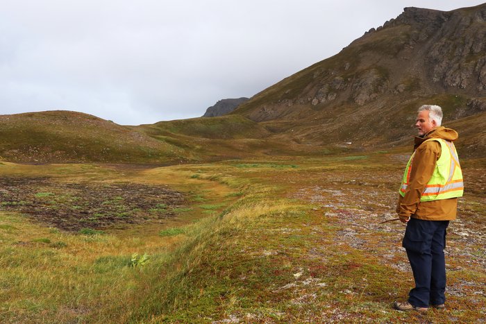 This shallow basin, which sometimes holds a pond, may be created by shifting blocks of rock as they teter 2600 feet above Grewingk Lake.