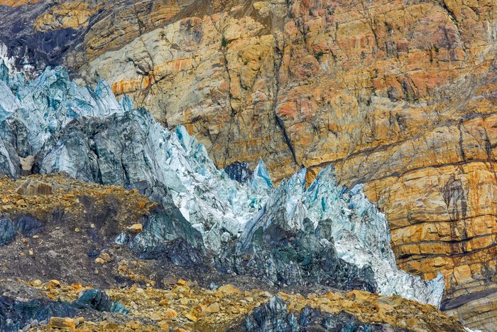 Tyndall Glacier and the orange Kluteith rock of upper Taan Fjord are striking, in both form and color. 