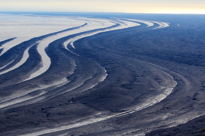 The curving stripes of moraine stretch out across the vast lobe of Malaspina Glacier