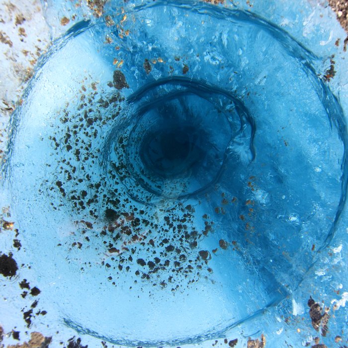 Holes filled with crystal clear water like this are common on the surface of Malaspina Glacier.