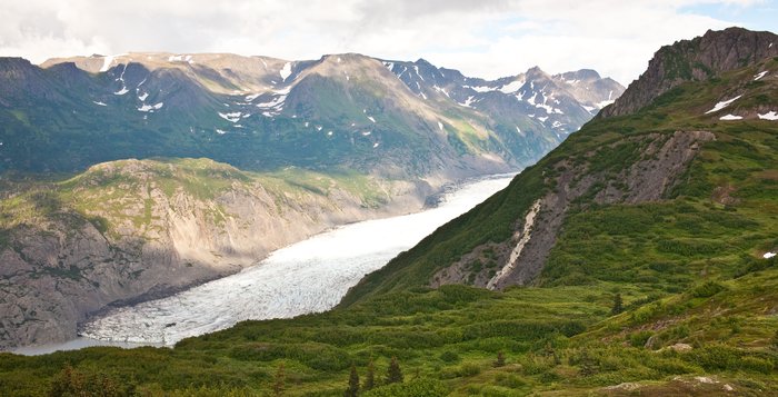 A hike along the southern ridge of the glacier shows it emerging from the mountains above