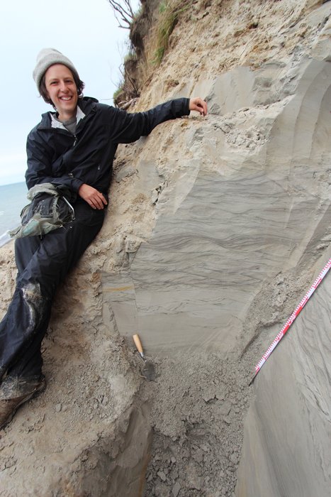 Hanna Craig of <a href="http://mediactionproject.org/">Media Action Project</a> poses next to an outcrop along the shore of Lake Iliamna.