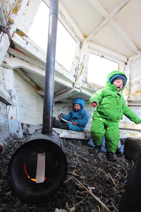 Katmai and Lituya hang out in a gravel-filled half-boat heated by our little <a href="http://www.titaniumgoat.com/">Titanium Goat</a> stove.