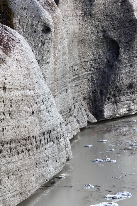 Pits seared out by the blinding sun show where sediment is more concentrated in the ice, providing dark material to absorb the sun.