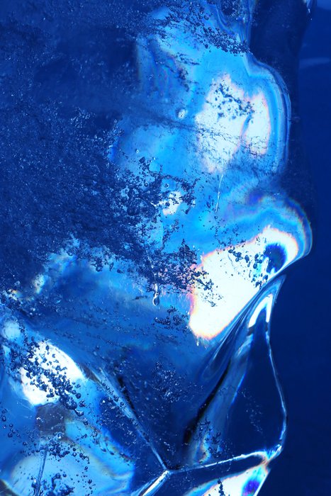 This thin fin of smooth glacial ice refracts the glacial scene behind it.