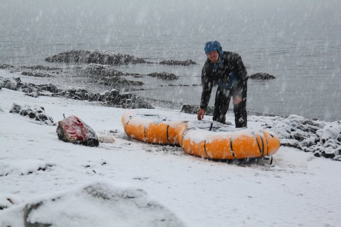 Attaching our two packrafts to a spruce pole to make a longboat - ready to make our way to Valdez on a cold December ocean.
