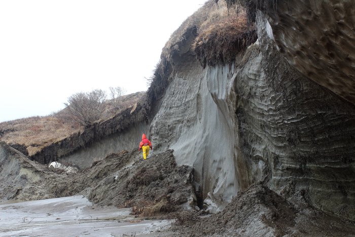 A hill melts into the Chukchi Sea, exposing ancient ice that forms much of the volume of the hill.