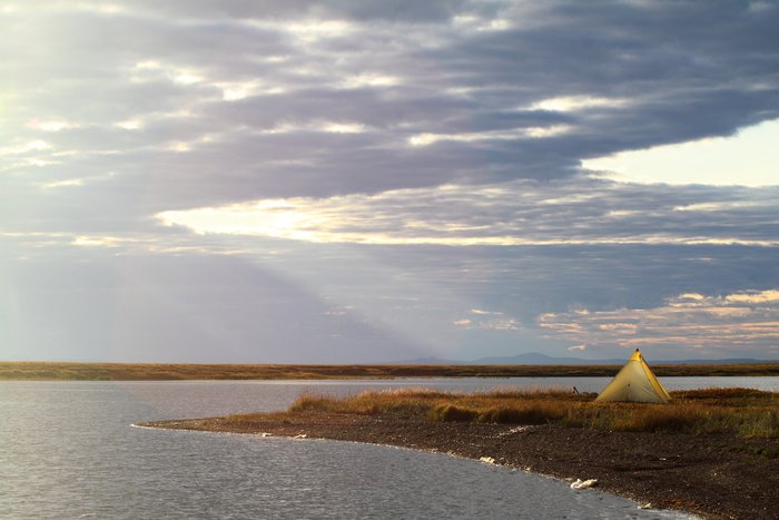 On a spit of land poking into an Arctic lagoon, our shelter glows.