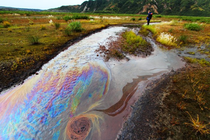 Naturally bleeding from the ground, oil colors a brisk little stream and gives the whole valley the smell of petrochemicals.