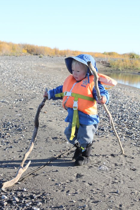 Even in calm water, the toddler wears an infant life vest and raingear for every boat ride.