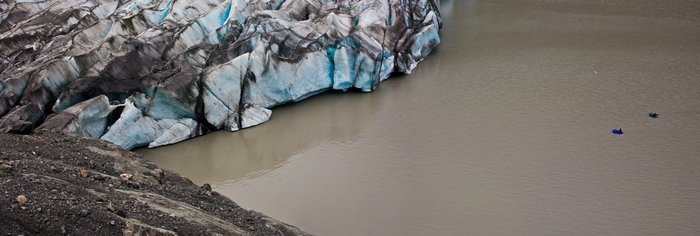 Bjorn and Kim pack raft near the snout of Grewinck, offering perspective to its size