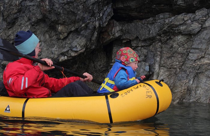 The bow of the packraft is the best place for a 3 year old to watch the cliffs go by.  He's easier to carry this way too.