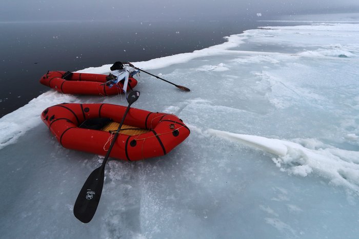 packrafts pulled onto the edge of a polynya near the York Mountains