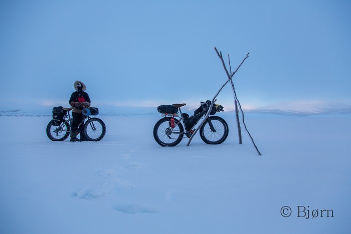 Riding through thick ice fog can be both beautiful and haunting. As the fog lifts and reveals daylight, Bjørn and Kim pause to appreciate the frozen dawn.