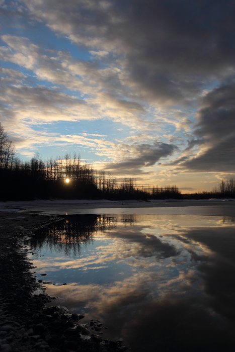 I really like this photo, I think in part because it is generically beautiful.  The beauty conceals the narrative behind it - the forever cold low sun of late fall, the partially frozen water suppressing waves...