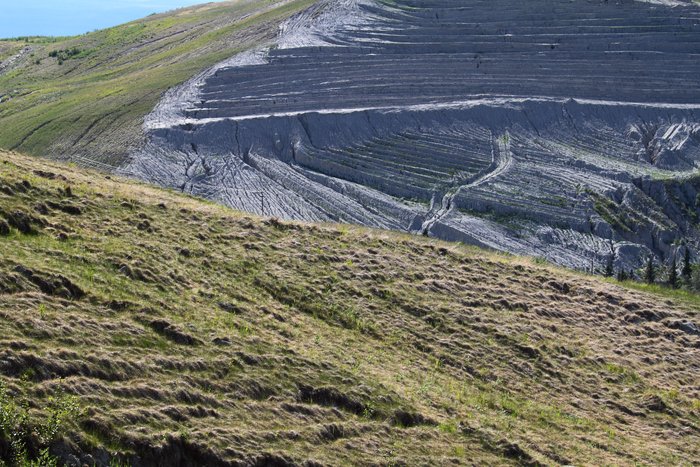 By planting grass and terracing slopes, reclamation crews are attempting to reduce erosion in the closed Poker Flats coal mine.