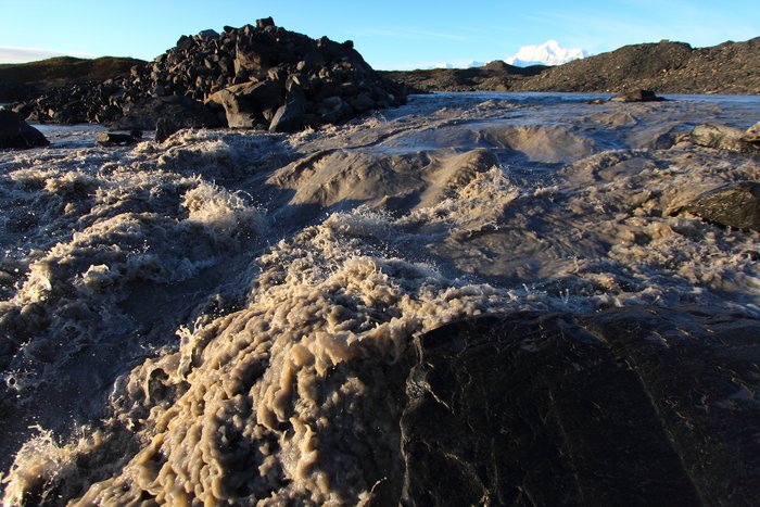 Only a two hundred yards upstream this boiling river emerges from the depths of the glacier.